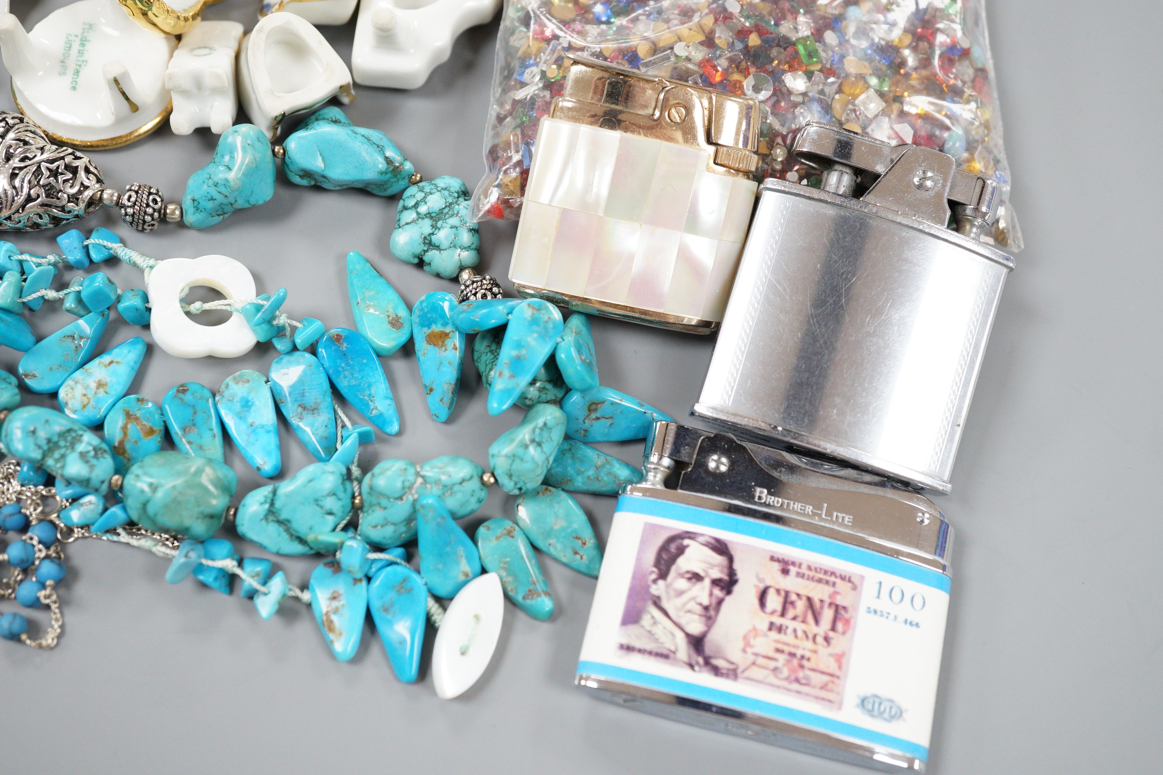 Nine miniature items of Limoges, including furniture, three turquoise necklaces, a group of assorted loose coloured paste stones and four assorted lighters.